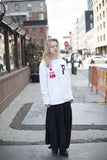 Candid shot of Four Flag Worldwide Hooded Windbreaker Coach Jacket in White on female model