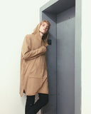 Candid shot of Elongated Hooded Pullover Trench in Khaki on model