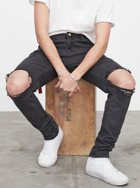 Washed faded black destroyed distressed denim jeans by profound aesthetic