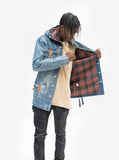 Showcasing plaid inner lining of Vintage Wash Denim Jacket w/ Genuine Leather