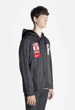 Side angle image of Four Flag Worldwide Hooded Windbreaker Coach Jacket in Black on model