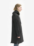 Right side angle view of Elongated Hooded Pullover Trench in Black on model