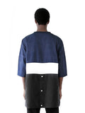 Back view of Color Blocked Elongated Split-Seam Windbreaker Nylon Pullover in Navy/White/Black on model