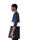 Left side image of Color Blocked Elongated Split-Seam Windbreaker Nylon Pullover in Navy/White/Black on model