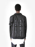 Back view of Lone Sentry Strap Jacket in Black on model, featuring strap details and large flap pocket