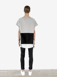 Head to toe back view of Cut-Off Color Blocked Kangaroo Sweatshirt Tee in Gray/Black on model with black denim and Basic Raw-Cut Elongated Short Sleeve Tee in Off-White