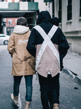 Candid photo of Fishtail Two-Tone Cargo Pocket Pullover in Black/Khaki alongside model wearing Elongated Cold War Work Jacket in Khaki