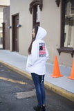 Candid shot of Four Flag Worldwide Hooded Windbreaker Coach Jacket in White on female model