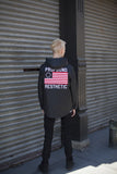 Full body candid shot of Four Flag Worldwide Hooded Windbreaker Coach Jacket in Black on model