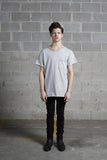 Front view of Basic Raw-Cut Elongated Short Sleeve Tee in Heather Gray on model