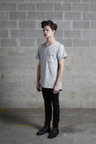 Side angle shot of Basic Raw-Cut Elongated Short Sleeve Tee in Heather Gray on model