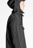 Hood up, right view of Torpedo Pocket Anorak Pullover Windbreaker Jacket in Midnight Black on model