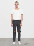 Washed faded black destroyed distressed denim jeans by profound aesthetic