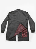 Flat back view of Waxed Cotton Long Bomber Jacket, showcasing deep oxblood satin lining 