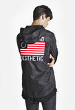 Back view candid shot of Four Flag Worldwide Hooded Windbreaker Coach Jacket in Black on model