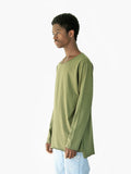 Side angle view of Basic Elongated Long-Sleeve Crewneck Tee in Olive on model