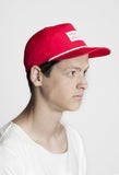 Side angle view of Nylon Snapback Box Logo Hat in Red on model