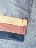 Layers of Pigment Dyed Basic Tee in Burnt Banana, Washed Rust, Faded Black, and Sandstone