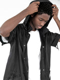 Candid shot of Half-Sleeve Detachable Hooded Coach Jacket Windbreaker in Black on model, showcasing hoodie