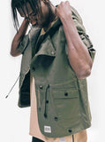 Candid side shot of Short-Sleeve Asymmetrical Hooded Parka in Olive on model