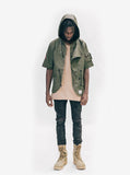 Head to toe shot of Short-Sleeve Asymmetrical Hooded Parka in Olive on model, showcasing hoodie