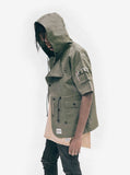 Candid side shot of Short-Sleeve Asymmetrical Hooded Parka in Olive on model