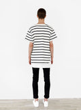 Head to toe shot of Neutral Stripe Half Sleeve Pullover Shirt in Black/Off-White paired with black denim