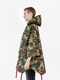 Left side view of Kengi Cotton Poncho in Woodland Camo on model