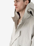 Close up candid shot of Silver Scale Longline Hooded Jacket in Silver, highlighting the neckline and hood