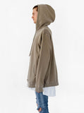 Side view of model wearing Pigment Dyed Washed Hoodie in Faded Khaki with hood up.