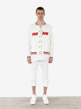 Head to toe shot of NY SoHo Baseball Jacket in Off-White on model, paired with white cut-off denim