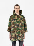 Model wearing Kengi Cotton Poncho in Woodland Camo, fully zipped