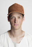 Front image of Textured Suede Snapback Hat in Camel Brown on model